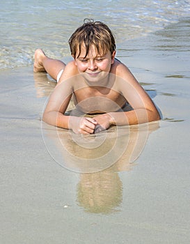 Boy at the beach enjoys the sandy beach