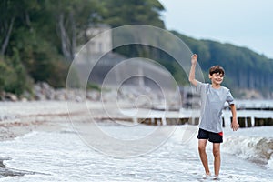 Boy on the beach. Family vacation by the sea. Active lifestyle