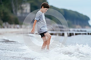 Boy on the beach. Family vacation by the sea. Active lifestyle