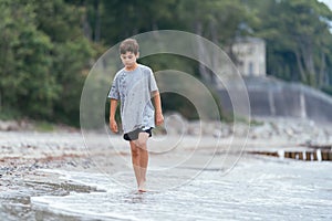 Boy on the beach. Family vacation by the sea. Active lifestyle