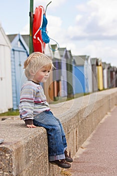 Boy by beach huts