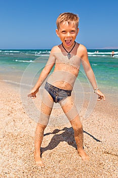 Boy on the beach with sea on background