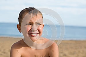 Boy on the beach sunbathing.