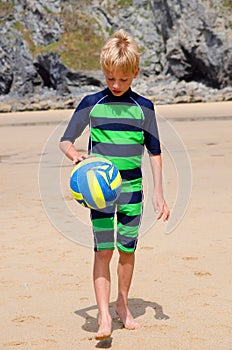 Boy on beach with volleyball