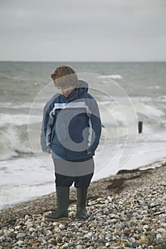 Boy on the beach in winter