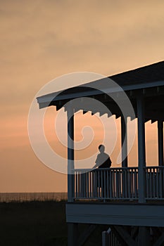 Boy on beachfront porch photo