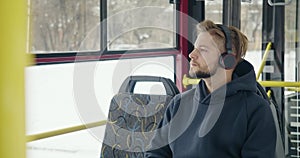 Boy with beard traveling by bus.