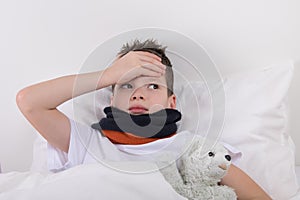 The boy in bed, his head hurts