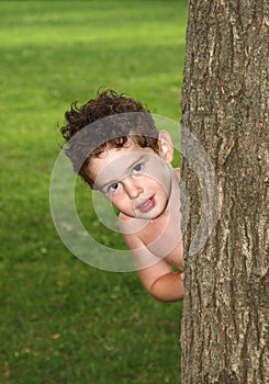 Boy behind tree