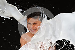 Boy being splashed by milk photo