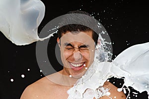 Boy being splashed by milk photo