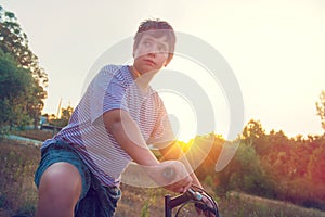 Boy in a bicycle outdoors