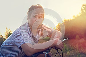 Boy in a bicycle outdoors