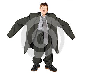 Boy in big man's suit and boots nads at sides