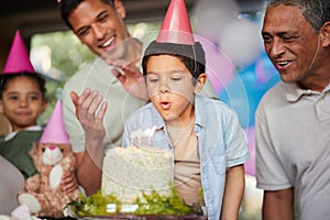 Boy, birthday party and blow candles with cake, celebration and support with applause, hat and happy in family home