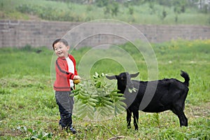 Boy and black goat