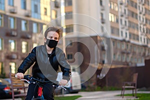 Boy in a black mask riding a bike