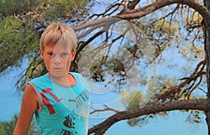 Boy with bloated nostrils against the background