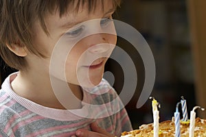Boy blow out celebratory candles