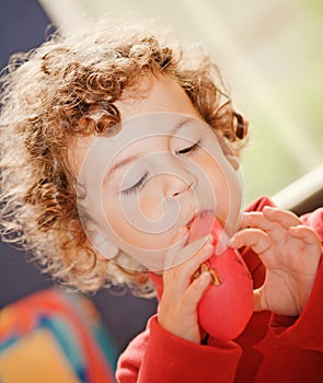 A boy blowing balloon