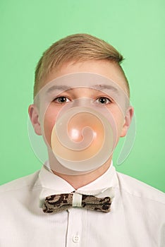 Boy blowing a bubblegum bubble.