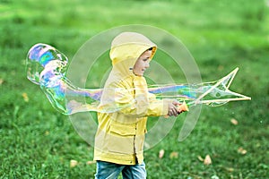 Boy blowing large bubbles