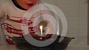 Boy Blowing Out Candle on Ice Cream Pie