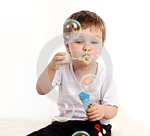 Boy blowing soap bubble