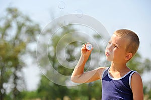 Boy blowing soap bubbles