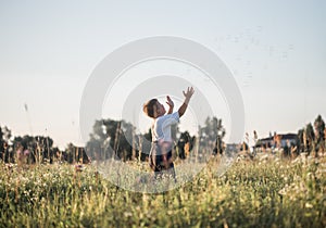 Boy blowing soap bubbles while an excited kid enjoys the bubbles. Happy teenage