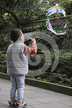 boy blowing soapbubble