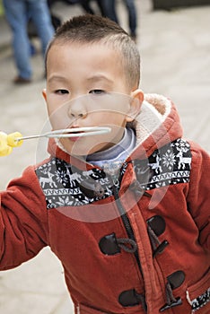 Boy blowing soapbubble