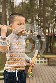 Boy blowing soapbubbles