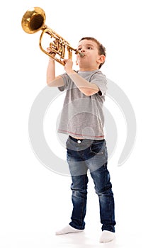 Boy blowing into a trumpet