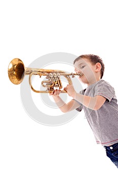 Boy blowing into a trumpet