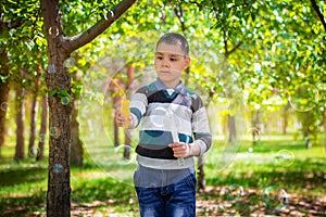 The boy blows soap bubbles in the park