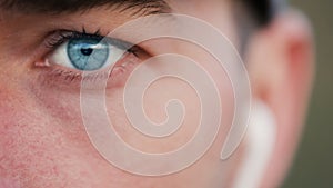 Boy with Blue Eyes Listens to Music