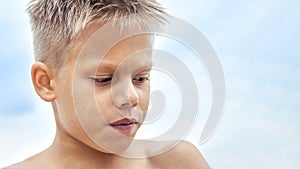 Boy with blue lips frozen from swimming in cold sea water