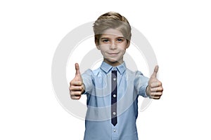 Boy in blue shirt showing okay with both hands on white background.