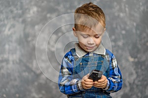 The boy in the construction glasses scratches his head photo