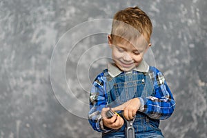 The boy in the construction glasses scratches his head photo