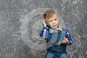 The boy in the construction glasses scratches his head photo