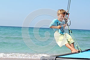 Boy on board of sea catamaran