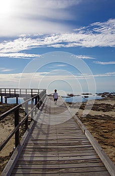 A boy on the boardwalk at Hamelin Pool, Shark Bay