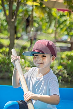 The boy boating in the park.
