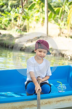 The boy boating in the park.