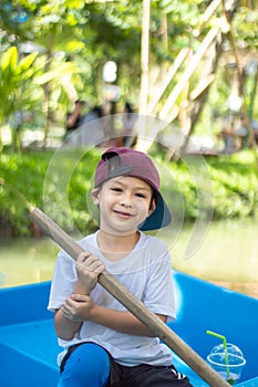 The boy boating in the park.