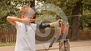 Boy with a bow and arrow. Bowman background. photo