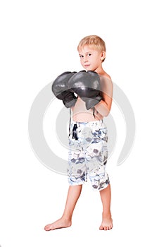 Boy in boxing gloves is isolated on white background