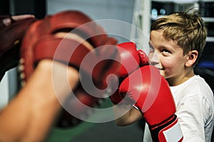 Boy Boxing Training Punch Mitts Exercise Concept photo